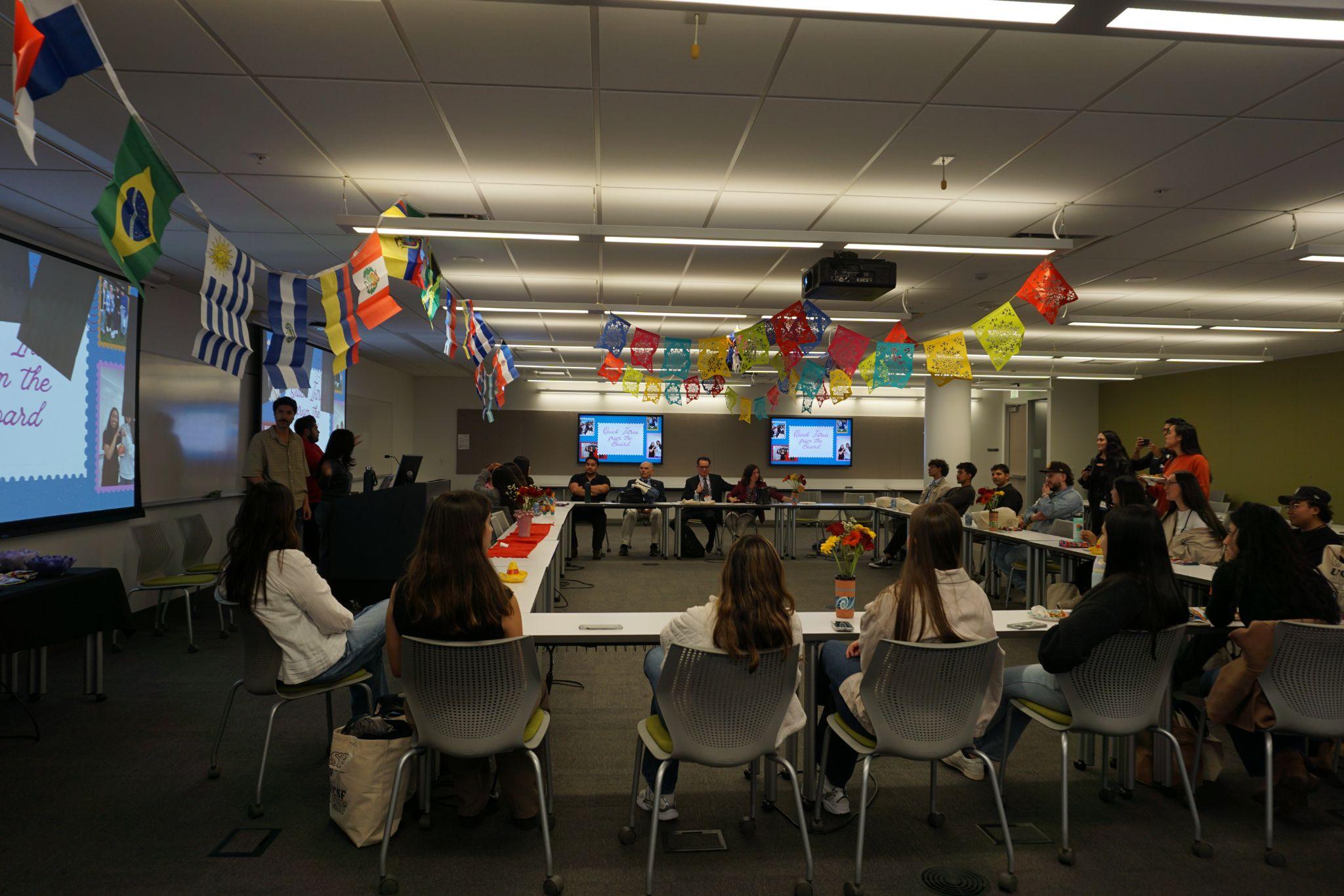 LMSA at UCSF members gathered with Latin American country flags at the Accepted Students Weekend Dinner.